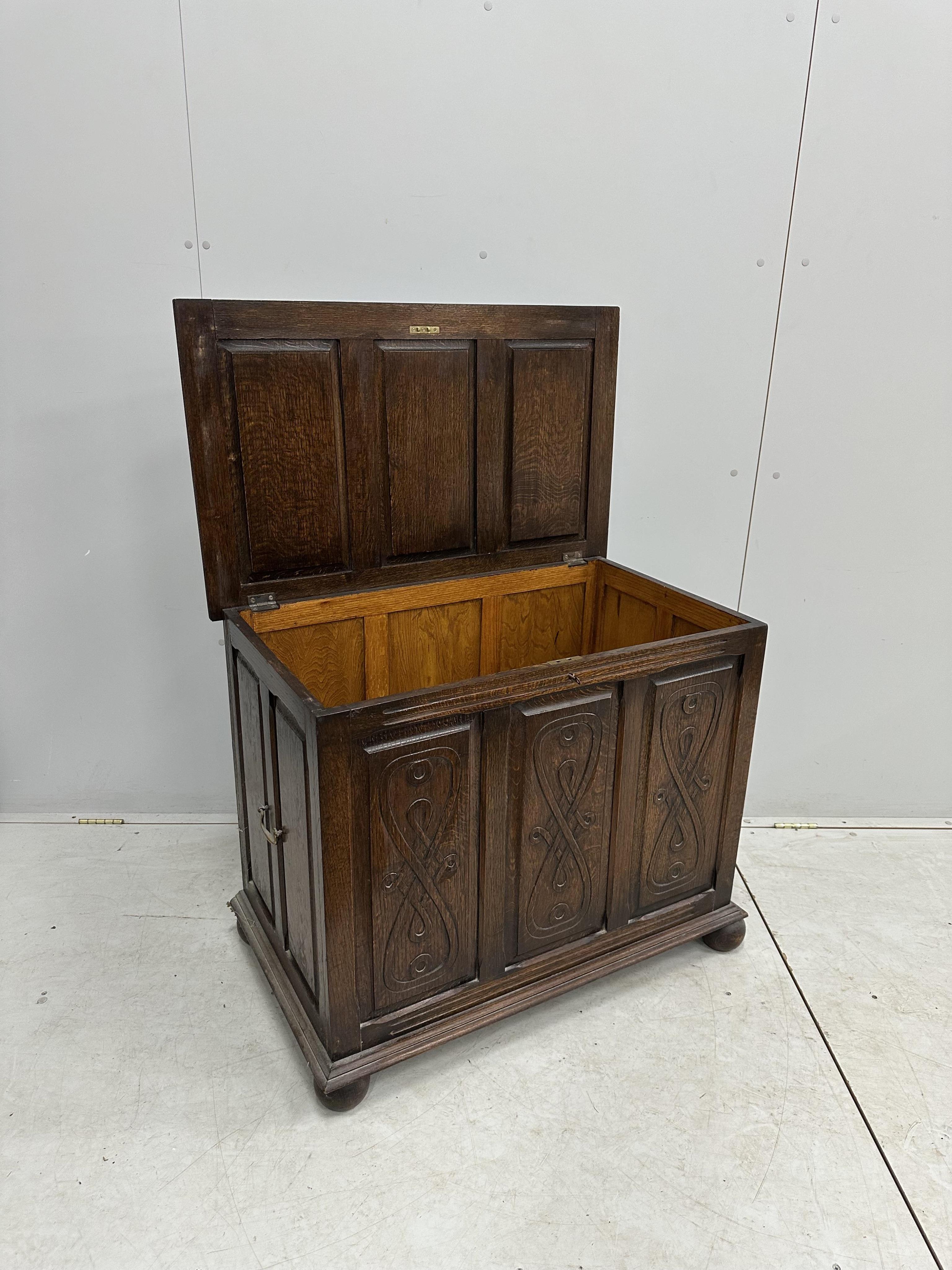 A 1930's carved oak coffer, width 91cm, height 73cm. Condition - good